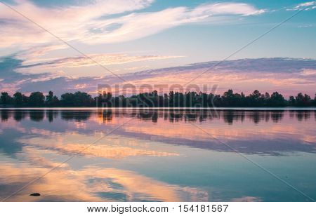 Colorful Morning Sunrise Reflecting In Clear Lake Waters