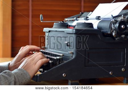 Hand Of A Young Woman Writer Writing On Antique Typewriter