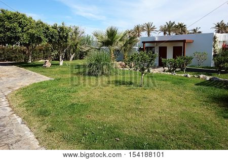 HERAKLION CRETE GREECE - MAY 13 2014: The blue sky modern building of villa and palms on the terrain of luxury class hotel on the Mediterranean coast of Crete May 13 2014 Greece.