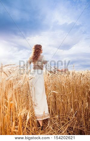 Pretty Woman Dressed In Embroidered Blouse In Wheat Field
