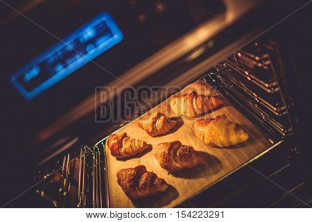 Croissant Electric Oven Baking. Tasteful Croissant Buttery Pastry.