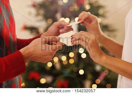 Cuple sharing Christmas wafer in traditional Polish way