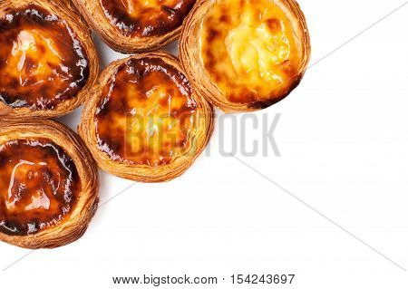 Egg Tarts isolated on white background. Heap of Typical portuguese dessert pasteis de nata close up