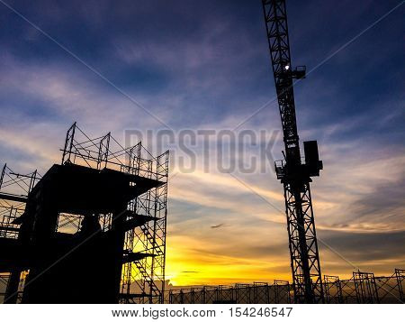 Silhouette Of Scaffolding In The Construction Site Before To Night Time Or Sunset Time. Worker Empty