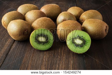 Kiwi fruits or chinese gooseberry on wooden table selective focus toned horizontal