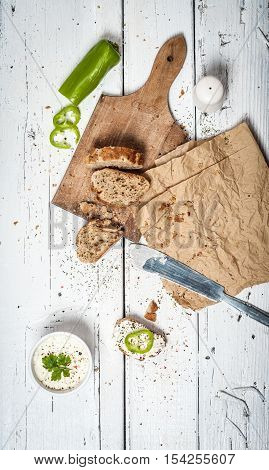 Homemade bread slices and soar cream on retro wooden table
