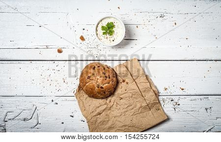 Homemade bun and soar cream on retro wooden table