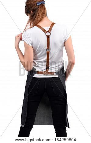 Young redhaired woman chef or waiter posing, wearing apron and white t-shirt isolated on white background