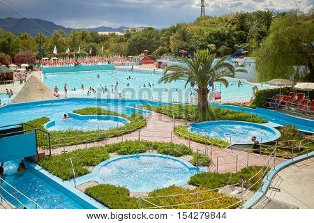 CERIALE, ITALY - AUG 05, 2016: People in swimming pools at aqua-park Caravelle. Aqua-park offers many attractions, including water slides and large swimming pools.