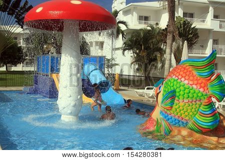 Negril Jamaica - October 15 2016. Happy kids having fun in the pool beach resort in Negril Jamaica.