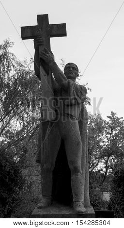 Statue of a man with a cross
