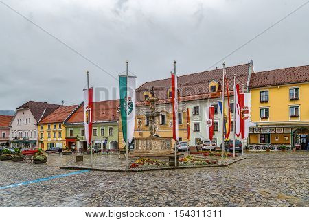 Main square with fountain and historical houses Friesach Austria