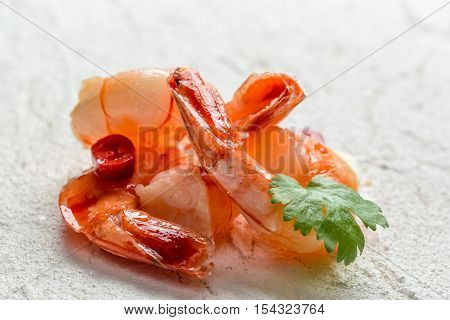 Closeup of fresh shrimp on a white rock