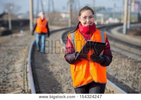 Man and a woman railroad workers maintaing railway