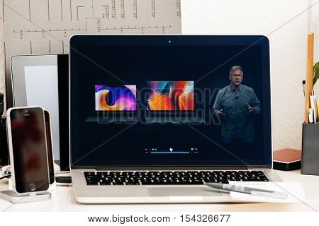 PARIS FRANCE - OCT 28 2016: Apple Computers website on new MacBook Pro Retina with OLED Touch bar in geek creative room showcasing Apple Keynote - Philip Schiller comparing new MacBook Pro Retina