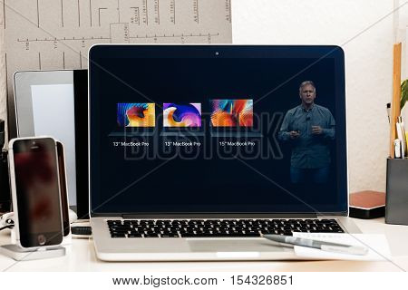 PARIS FRANCE - OCT 28 2016: Apple Computers website on new MacBook Pro Retina with OLED Touch bar in geek creative room showcasing Apple Keynote Comparing Shipping Price Specs of laptops