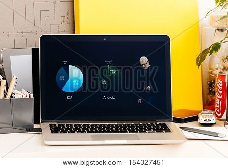 PARIS FRANCE - OCT 28 2016: Apple Computers website on new MacBook Pro Retina with OLED Touch bar in geek creative room showcasing Apple Keynote presentation of iOS vs Android adoption users