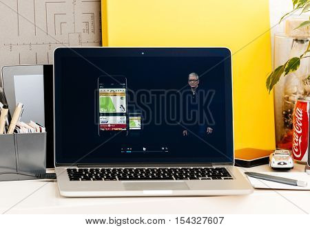 PARIS FRANCE - OCT 28 2016: Apple Computers website on new MacBook Pro Retina with OLED Touch bar in geek creative room showcasing Apple Keynote presentation of Apple Pay in Japan by Tim Cook