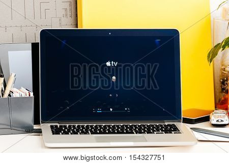 PARIS FRANCE - OCT 28 2016: Apple Computers website on new MacBook Pro Retina with OLED Touch bar in geek creative room showcasing Apple Keynote presentation of Apple TV new TV app