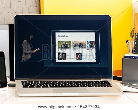PARIS FRANCE - OCT 28 2016: Apple Computers website on new MacBook Pro Retina with OLED Touch bar in geek creative room showcasing Apple Keynote presentation of Apple tv Watch now TV app channels movies and shows