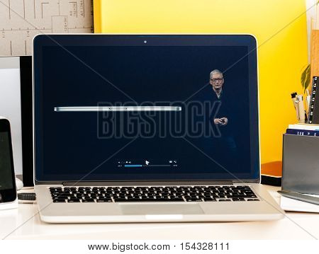 PARIS FRANCE - OCT 28 2016: Apple Computers website on new MacBook Pro Retina with OLED Touch bar in geek creative room showcasing Apple Keynote Tim Cook talking about the MacBook Pro and its advantages