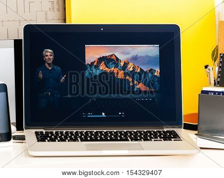 PARIS FRANCE - OCT 28 2016: Apple Computers website on new MacBook Pro Retina with OLED Touch bar in geek creative room showcasing Apple Keynote presentation Craig Federighi talking about new MacBook Pro