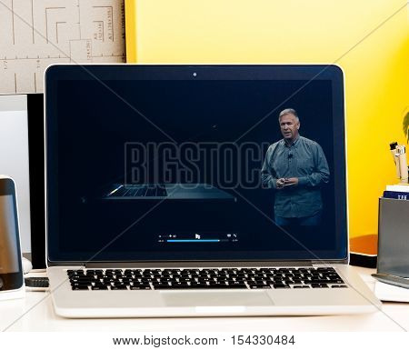 PARIS FRANCE - OCT 28 2016: Apple Computers website on new MacBook Pro Retina with OLED Touch bar in geek creative room showcasing Apple Keynote presentation of Philip Schiller inegration software