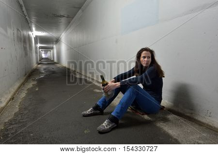 Drunk Woman Drinks Alcohol In A Tunnel