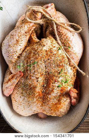 Spiced chicken with herbs in casserole dish