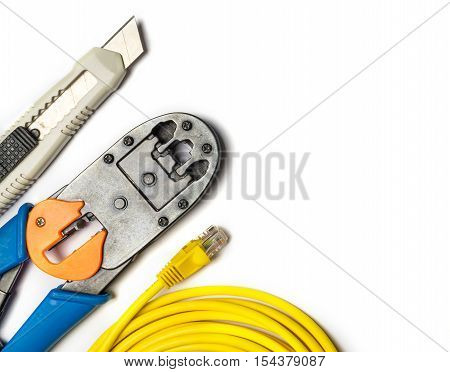 Cutter crimper yellow patch cord on white background. Top view