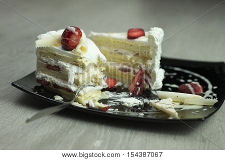 Delicious slice of cake with forks shallow depth of field