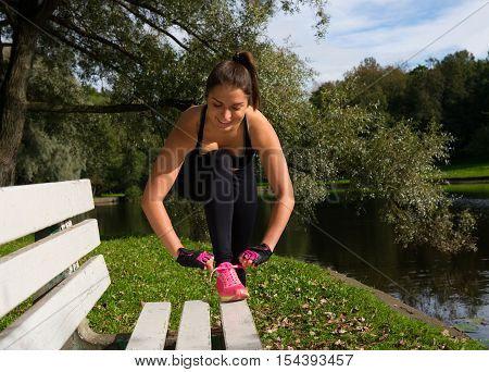 Women tied the laces on sport shoes. Preparing for jogging and exercises