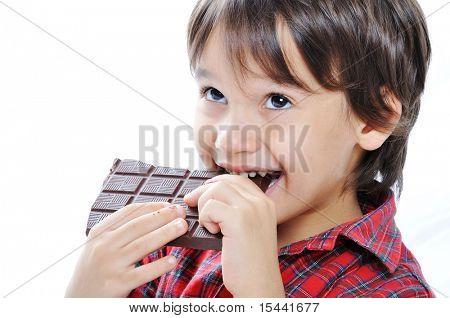 Cute kid isolated on white eating chocolate