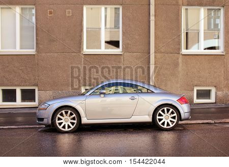 HELSINKI FINLAND - AUGUST 10 2016: Side view of stylish car parked at the famous Ullanlinna District on Laivanvarustajankatu street in Helsinki Finland just after a rain shower August 10 2016.