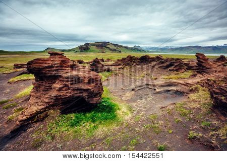 Sandy rocks with by magma formed by winds. Popular tourist attraction. Unusual and gorgeous scene. Location Sudurland, cape Dyrholaey, south coast of Iceland, Europe. Artistic picture. Beauty world.