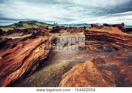 Sandy rocks with by magma formed by winds. Popular tourist attraction. Unusual and gorgeous scene. Location Sudurland, cape Dyrholaey, south coast of Iceland, Europe. Artistic picture. Beauty world.