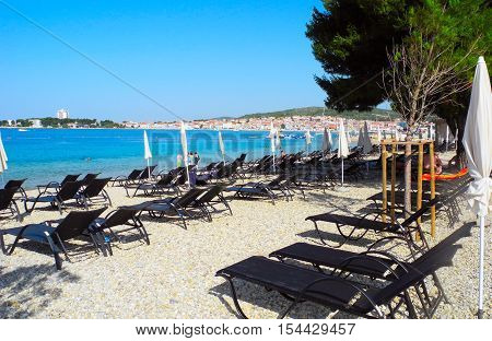 Sun loungers on the pebble beach in Vodice in Croatia.