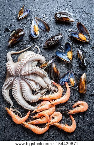 Three kinds fresh seafood on black rock
