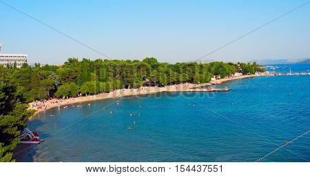 View from the pier on the beach with pines in Vodice Croatia.