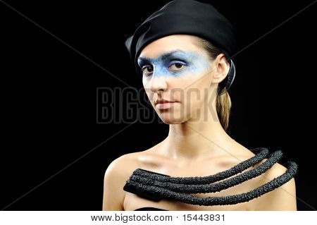 Azafata muy guapa con pañuelo oscuro, collar, vestido y los ojos de máscara colorido, moda con estilo mod