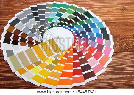 collection of ral colours on wooden background. colored paper