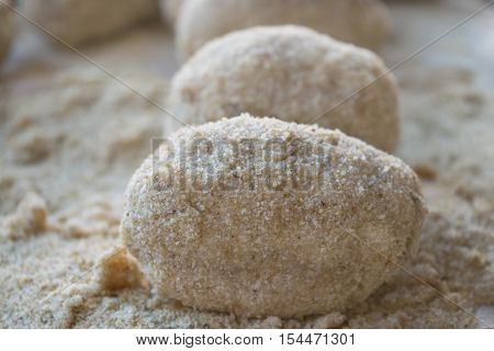 preparation of sicilian arancine with breadcrumbs on a paper