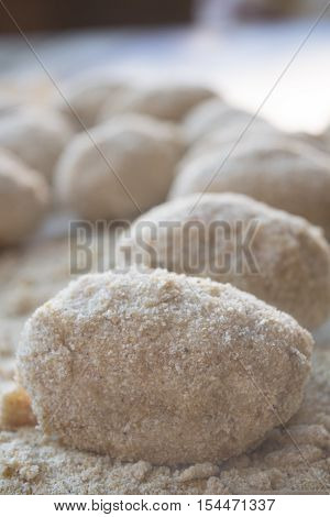preparation of sicilian arancine with breadcrumbs on a paper