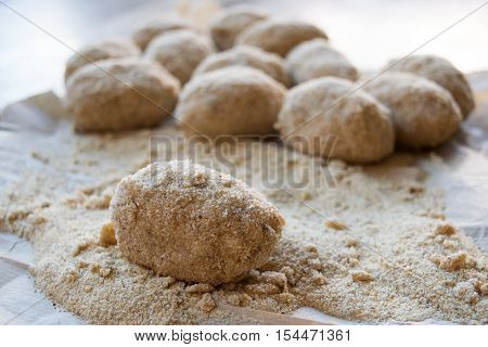 preparation of sicilian arancine with breadcrumbs on a paper