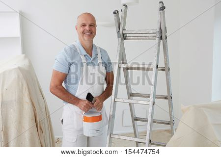 Portrait Of Decorator Painting Room In House