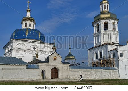 Abalak, Russia - May 2, 2010: Man goes near Sacred Znamensky temple. Egypt Saint Maria church of Abalak Znamenski Monastery. Situated in the village 20km from Tobolsk. Siberia