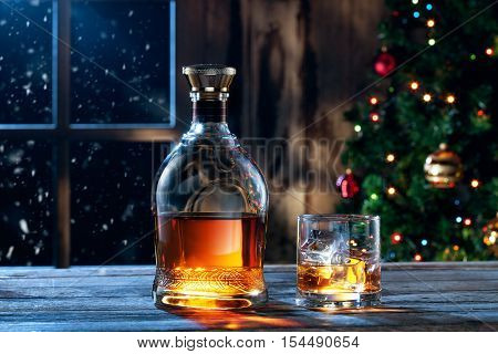 close up view  of glass  with whiskey and bottle  on color back