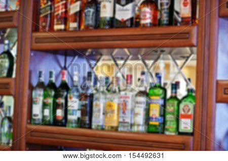 Blur Efferct Of Several Types Of Bottled Alcohol Are Displayed On Some Shelves In A Restaurant