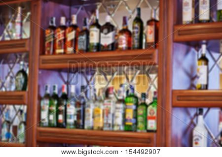 Blur Efferct Of Several Types Of Bottled Alcohol Are Displayed On Some Shelves In A Restaurant