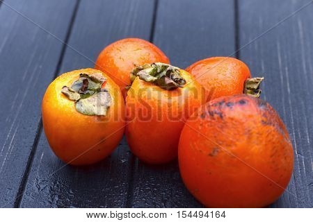 persimmon Fresh ripe persimmon on wooden table fruits on rustic table tropical fruit